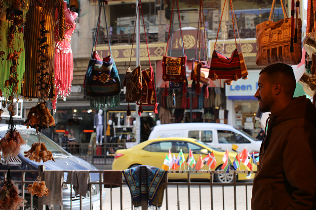 An employee at a tourist shop in downtown Amman is seen waiting for customers in this recent photo  (Photo by Hanna Davis)