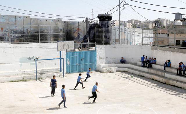 Palestinian students play football at an UNRWA-run school in Aida refugee camp in Bethlehem, in the occupied West Bank after the US withdrew funding from UNRWA last year. Despite an outpouring of donations from the international community and private donors, the organisation recently said it faces a $1.2 billion funding shortfall for 2019 (Reuters file photo)