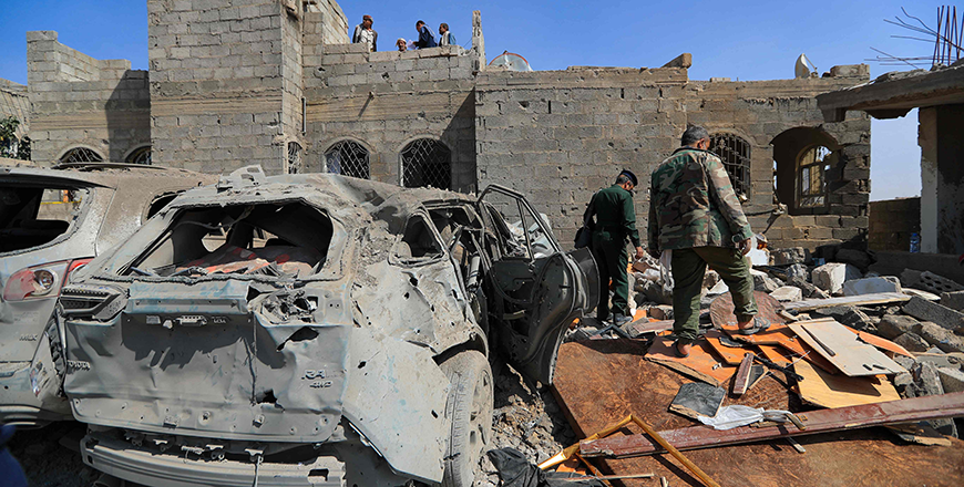Huthi rebel fighters inspect the site of a reported US airstrike in Sanaa, a day after the attack, on April 7, 2025 (AFP photo)