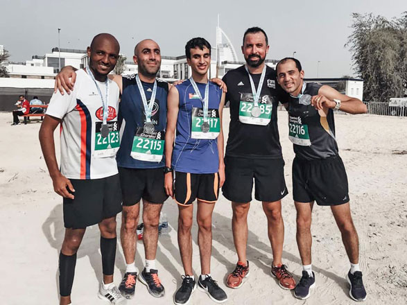 In this undated photo, Hasan Tayem (centre) poses for a photo after a race in Dubai  (Photo courtesy of Facebook)