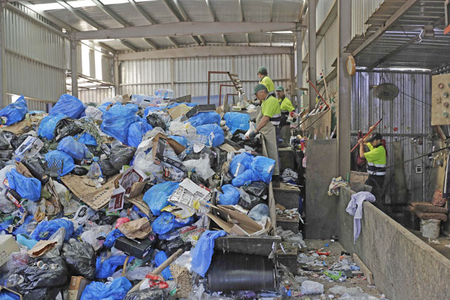 Workers are seen at a waste treatment plant in the area of Monteverde east of Beirut  on October 27 (AFP photo)