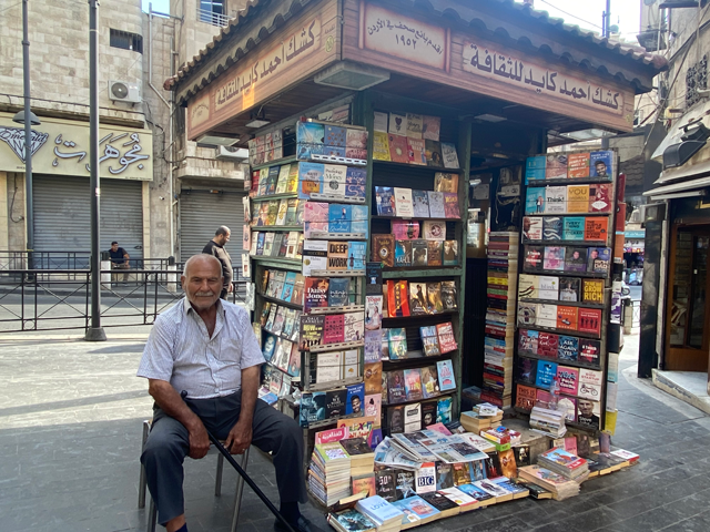Book vendor Ahmad Kayed next to his bookstall in downtown Amman on Saturday (Photo courtesy of Mays Ibrahim Mustafa)