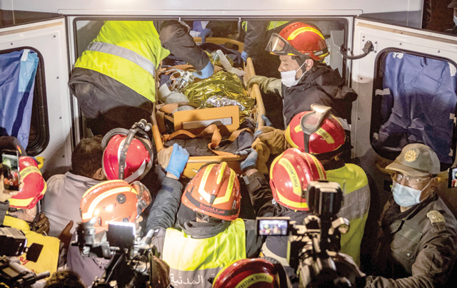 Moroccan emergency teams place the body of five-year-old Rayan Oram in an ambulance after pulling him from a well shaft he fell into on February 1, in the remote village of Ighrane in the rural northern province of Chefchaouen, late on Saturday (AFP photo)