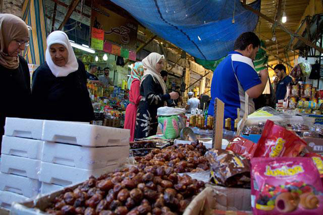 In this undated photo, shoppers examine merchandise at a market in downtown Amman. (Photo by Amjad Ghsoun)