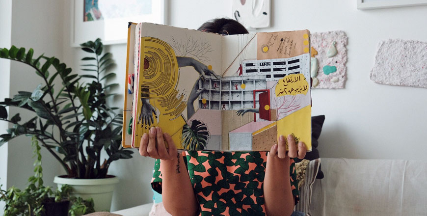   In this undated photo, Nahla Tabbaa holds Daftar Asfar. The first edition, along with other editions of the sketchbook, will go on display in Dubai, on Wednesday (Photo by Darah Ghanam)