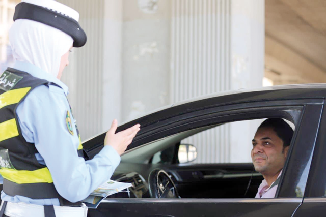 Traffic officers on Wednesday began distributing brochures to motorists urging them to wear seatbelts (Photo courtesy of Traffic Department Facebook page)
