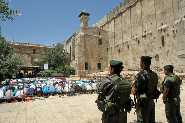 Palestinians perform Friday prayers outside the Ibrahimi Mosque in the West Bank city of Hebron. The World Heritage Committee recently decided to keep the mosque and city on its lists of endangered world heritage sites (AFP photo)