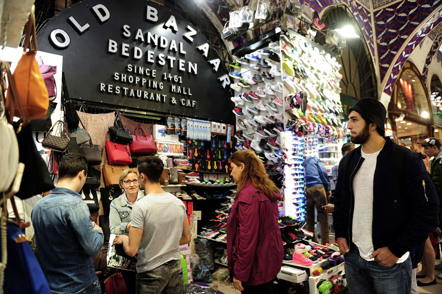 People walk past the blocked Sandal Bedesten gate (left) last week at historical Grand Bazaar in Istanbul (AFP photo)