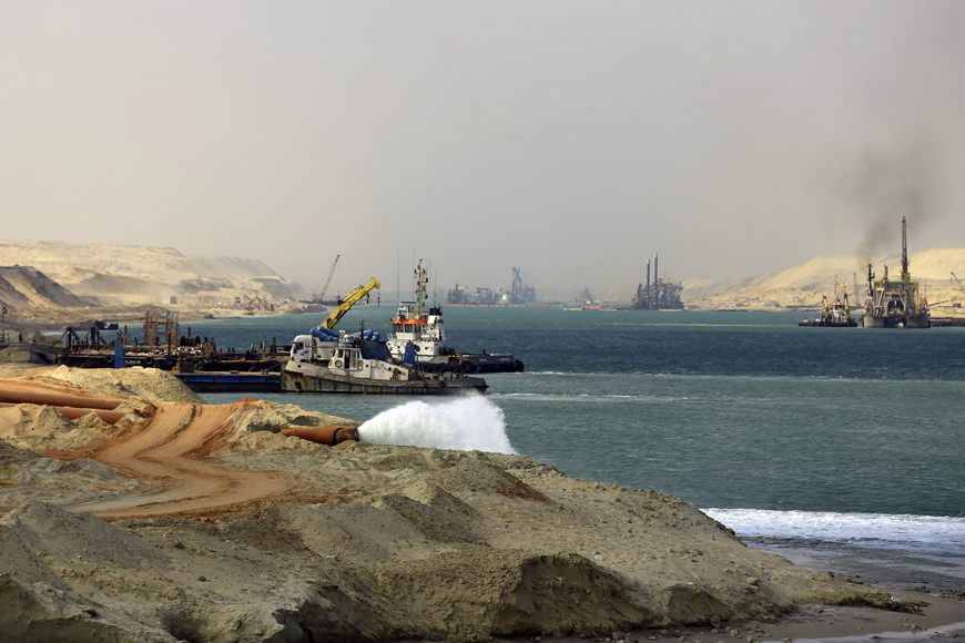 Dredgers work on a new section of the Suez Canal during a media tour in Ismailia, Egypt, Saturday (AP photo)