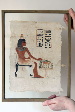 A file photo taken on June 1 in Paris shows a person holding up Ta-Nedjem’s funerary linen, a rare Egyptian polychrome linen square with a funerary painting dating from the 18th dynasty of Egypt (1400-1300 BC) (AFP photo)