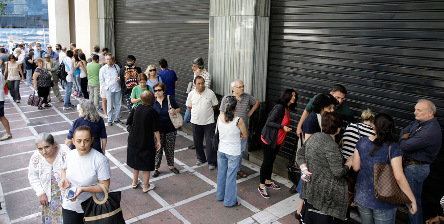 People stand in a queue outside a bank which operates on Saturday but eventually didn't open, in central Athens, on Saturday (AP photo)
