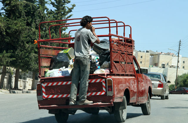 A pickup truck carries items scavenged from garbage containers in Amman (File photo)
