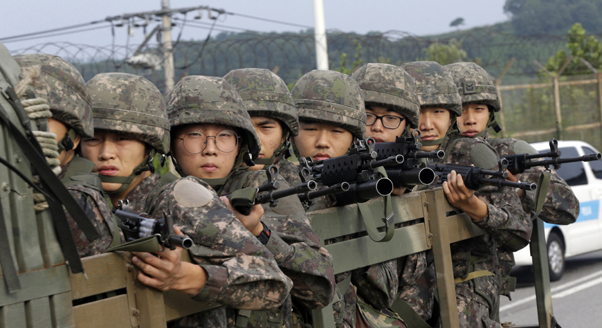 South Korean army soldiers ride on a truck in Paju, south of the demilitarised zone that divides the two Koreas, South Korea, on Monday (AP photo)