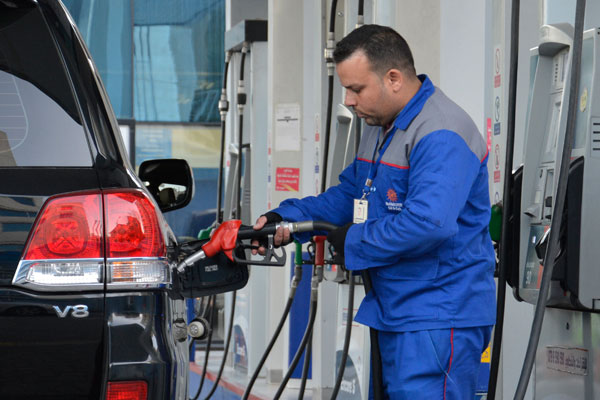 A gas station attendant fills a car with fuel in Amman recently (Photo by Amjad Ghsoun)