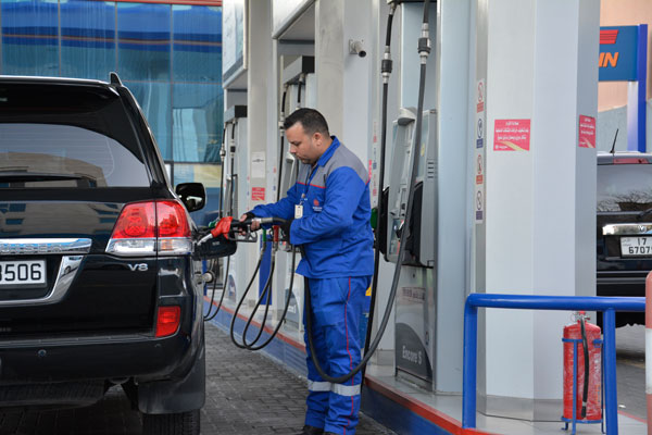 A gas station attendant serves a customer in Amman recently (Photo by Amjad Ghsoun)