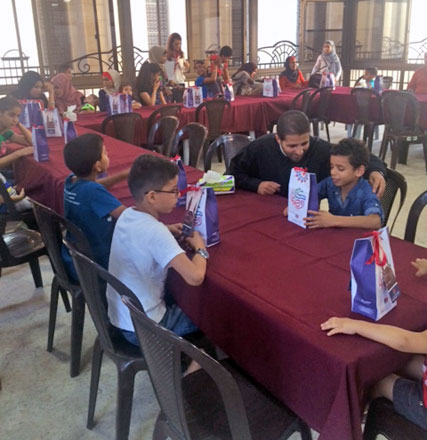 Children from the SOS Children's Village break their fast in Amman on Tuesday at an iftar banquet organised by church scouts in cooperation with the Restaurant of Mercy (Photo by Rula Samain)