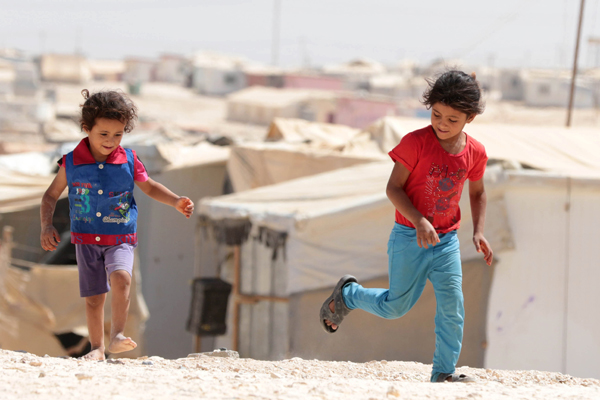 Young Syrian refugees play at the Zaatari camp, northeast of Amman, on Saturday. UN Humanitarian Chief Stephen O’Brien visited the camp during the day (AFP photo by Khalil Mazraawi)