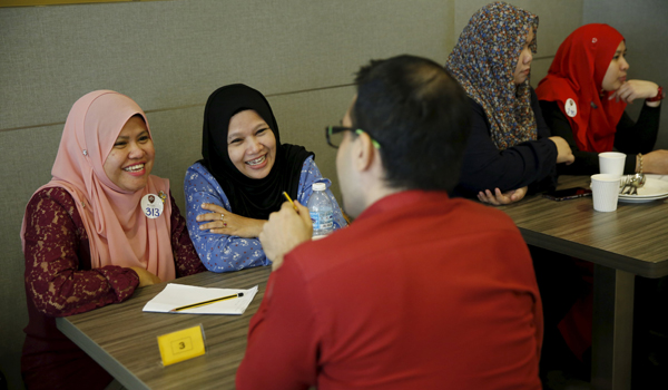 Majudi (left), with her chaperone Norwati (2nd from left), smile at Halal Speed Dating, a matchmaking event, in Kuala Lumpur, Malaysia, last week (Reuters photo)