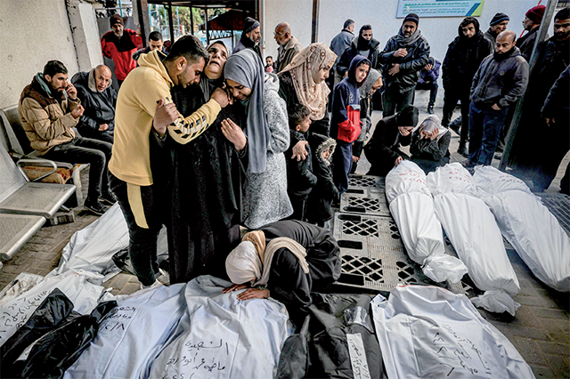 Palestinians mourn after identifying corpses of relatives killed in overnight Israeli bombardment on the southern Gaza Strip at Al Najjar hospital in Rafah on February 8 (AFP photo)