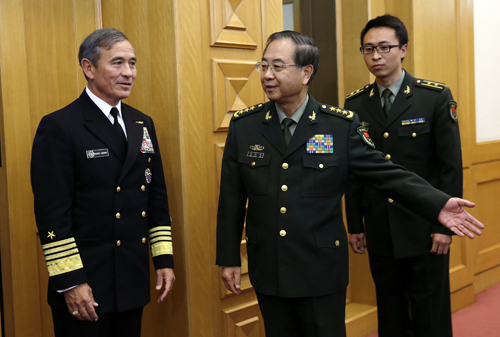 Admiral Harry B. Harris, Jr, US Navy Commander, US Pacific Command (left) is shown the way by China’s General Fang Fenghui, People’s Liberation Army chief of staff, as they proceed to their meeting at the Bayi Building in Beijing, China, on Tuesday (AP photo)