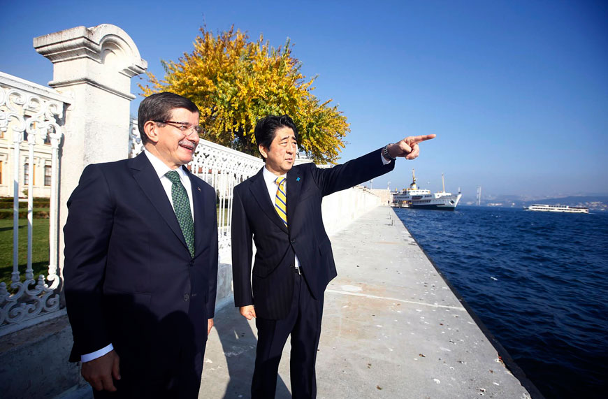 Japan’s Prime Minister Shinzo Abe (right) and his Turkish counterpart Ahmet Davutoglu speak as they stand on the Bosphorus in Istanbul, on Saturday (AP photo)