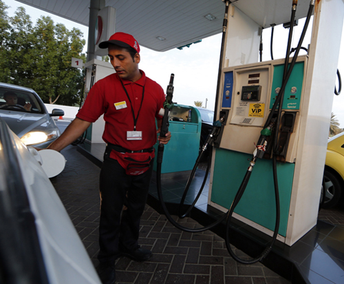 A worker fills a car with petrol at a gas station in Dubai on Tuesday (AFP photo)