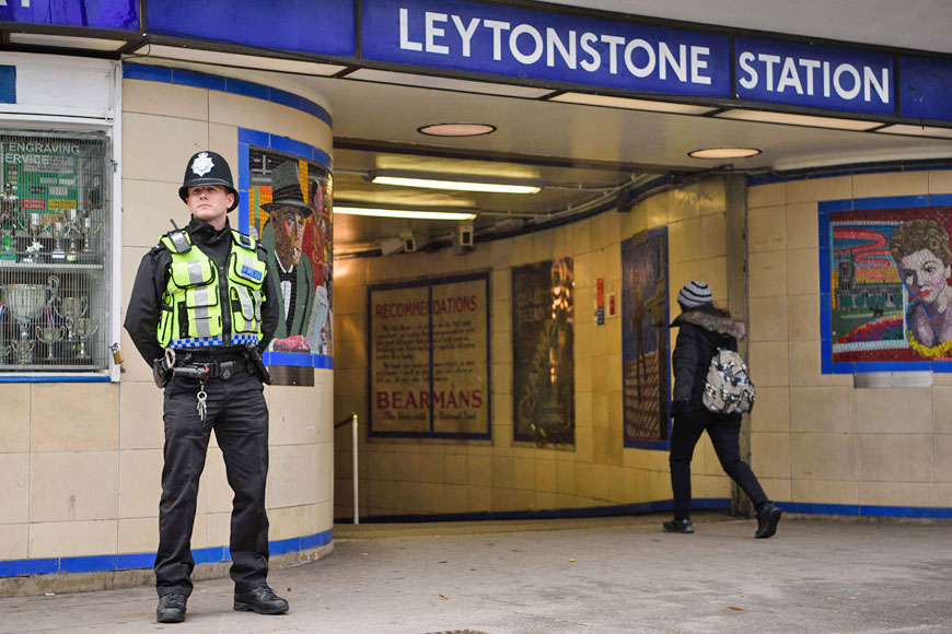 A police officer stands guard outside Leytonstone station in north London on Sunday, a day after a stabbing attack in what police are treating as a ‘terrorist incident’  (AFP photo)