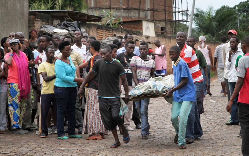Men carry away a dead body in the Nyakabiga neighbourhood of Bujumbura, on Saturday (AP photo)