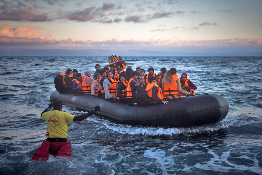 Refugees and migrants arrive on a dinghy from the Turkish coast to the Greek island of Lesbos, on Friday (AP photo)