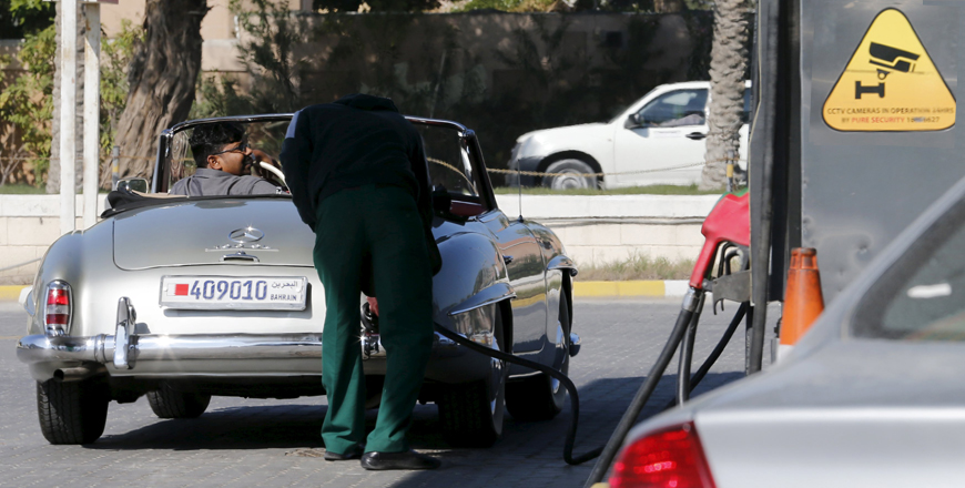 A petrol station attendant refuels a car at a petrol station in Budaiya, west of Manama, Bahrain, on Tuesday (Reuters photo)