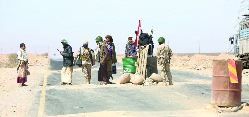 Soldiers and tribal fighters loyal to Yemen's government man a checkpoint in the country's northern city of Marib, on Wednesday (Reuters photo)