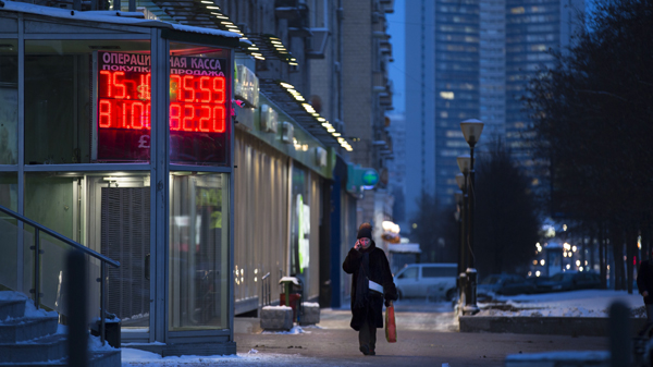 A woman walks past at an exchange office sign showing the currency exchange rates of the Russian ruble, US dollar, and euro in Moscow, Russia, on Monday (AP photo )