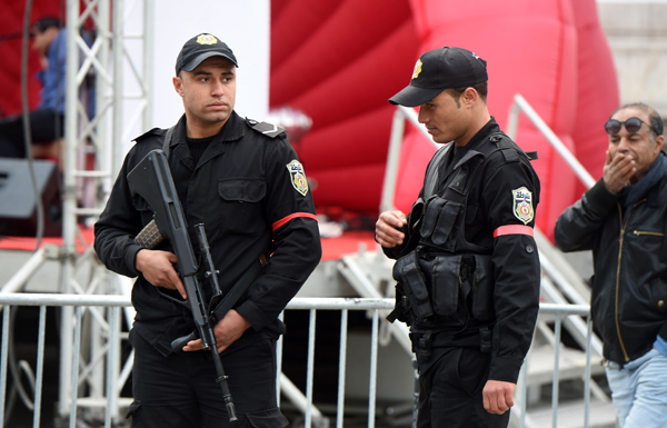 Tunisian policemen, stand guard on Habib Bourguiba Avenue in Tunis, on Monday (AFP photo)