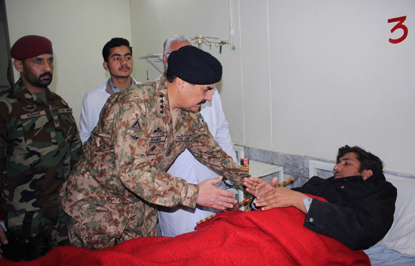 Pakistan’s army chief Raheel Sharif talks to a man injured in an attack on a university, at a local hospital in Charsadda town, some 35 kilometres outside the city of Peshawar, Pakistan, on Wednesday (AP photo)