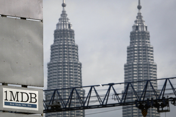 In this Wednesday, July 8, 2015 photo, a 1MDB (1 Malaysia Development Berhad) logo is set against the Petronas Twin Towers at the flagship development site, Tun Razak Exchange in Kuala Lumpur (AP photo)