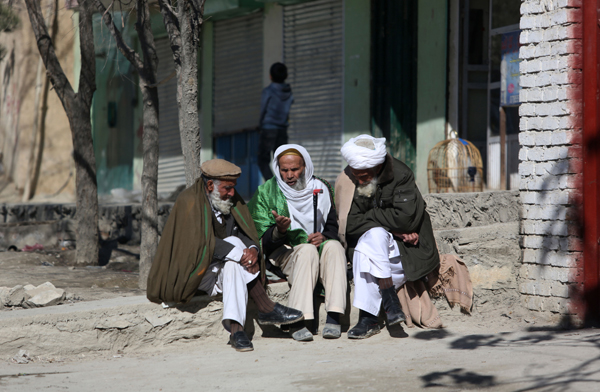 Elderly Afghan men chat on the outskirts of Kabul, Afghanistan, on Sunday (AP photo)