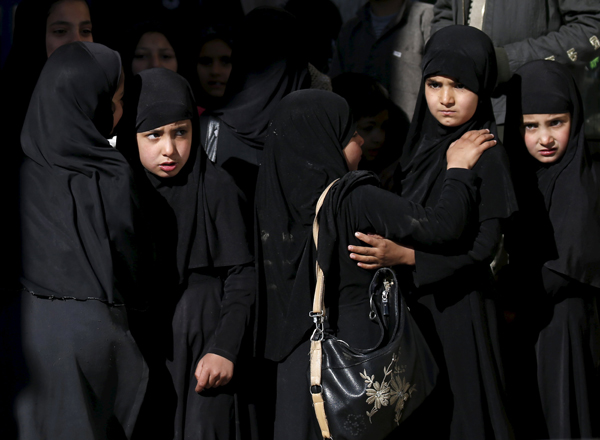 Girls look on at the site of a suicide attack in Kabul, on Sunday (Reuters photo)