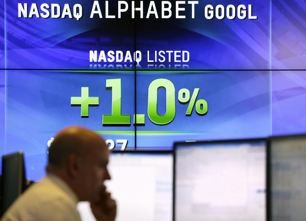 Electronic screens post the price of Alphabet stock, on Monday, at the Nasdaq MarketSite in New York (AP photo)
