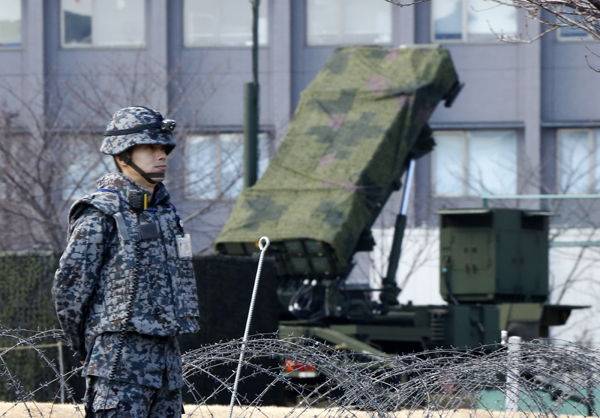 A Japan Self-Defence Force member stands by a PAC-3 Patriot missile unit deployed for North Korea’s rocket launch at the defence ministry in Tokyo, on Sunday (AP photo)