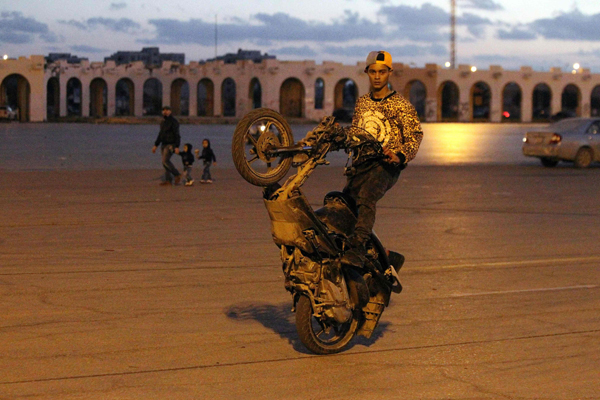A Libyan youth performs stunts on a scooter in the square of the eastern coastal city of Benghazi on Monday during a festival organised by the city’s Motorcycle Club and Arabian Horse Club. Libyans participated in the event to show that the city is not simply controlled by militia groups (AFP photo)