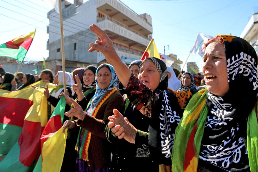Kurdish women hold flags and shout slogans during a demonstration against the exclusion of the Syrian Kurds from the Geneva talks, in the northeast Syrian Kurdish city of Qamishli, on Thursday (Reuters photo)