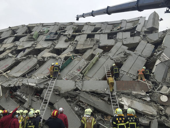 Rescue personnel work at the site where a 17-storey apartment building collapsed from an earthquake in Tainan, southern Taiwan, on Saturday (Reuters photo)