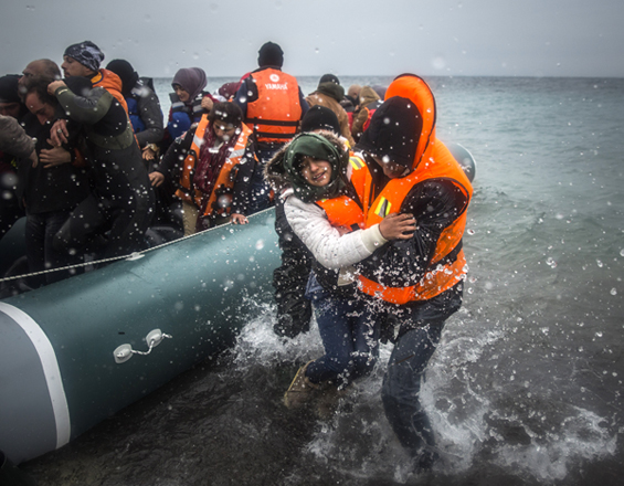 In this January 3 file photo, refugees and migrants disembark on a beach after crossing a part of the Aegean Sea from Turkey to the Greek island of Lesbos (AP photo)