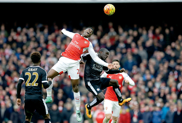 Arsenal’s Danny Welbeck (centre left) jumps for the ball during the English Premier League football match between Arsenal and Leicester City at the Emirates Stadium in London, on Sunday  (AP Photo by Matt Dunham )