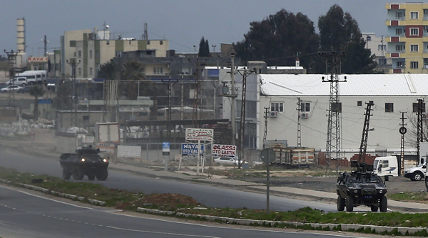 Turkish forces’ armoured vehicles patrol at the southeastern town of Nusaybin, Turkey, near the border with Syria, where Turkish security forces are battling militants linked to the outlawed Kurdistan Workers Party (PKK), on Sunday, a day after Turkish media reports said a police officer was injured in a clash (AP photo)