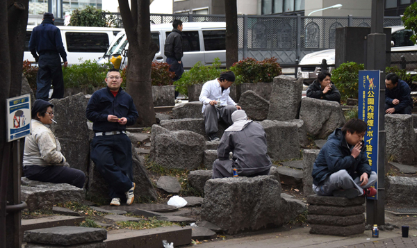 Workers take a rest at a park beside a construction site in Tokyo on Monday (AFP photo)
