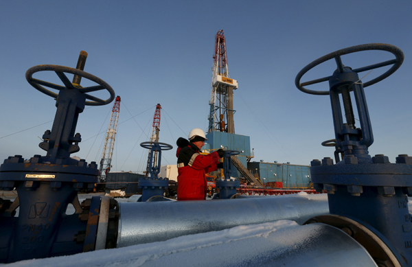A worker checks an oil pipe at an oil field  in Russia in this file photo. Iran is showing no support for a global deal to restrain oil production to prop up prices (Reuters photo)