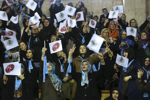 Iranian women cheer as they wave flags of reformists for the parliamentary elections in a campaign rally in Tehran, on Thursday (AP photo)