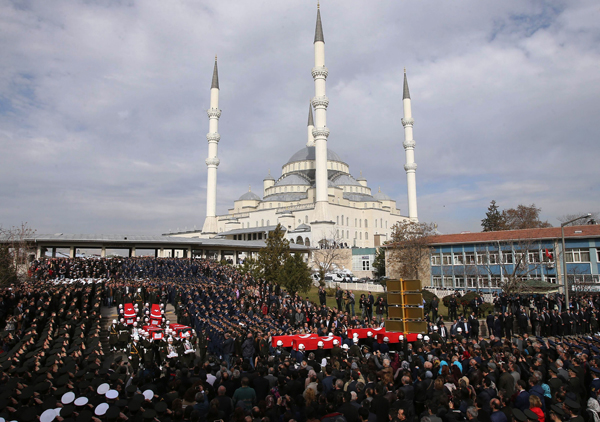 Honour guards carry the Turkish flag-draped coffins of car bombing victims during a funeral ceremony at Kocatepe Mosque in Ankara on Friday (AFP photo)
