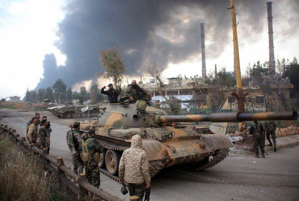 Syrian government forces patrol near Aleppo's thermal power plant after they took control of the area on the eastern outskirts of Syria's northern embattled city from Daesh group, on Sunday (AFP photo)